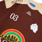 Camiseta Rolimã Racing Marrom com estampa arco iris e detalhes em bege da marca "SOPRO"
