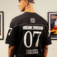 Camiseta preta Rolimã Racing com estampa colorida de arco-íris e logo da marca SOPRO.